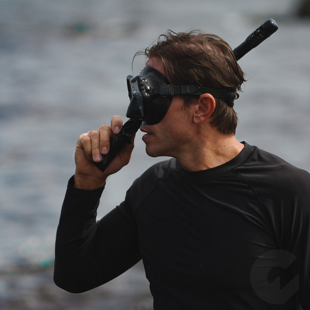 Adult model wearing G2rise snorkeling mask, designed for underwater breathing and exploration