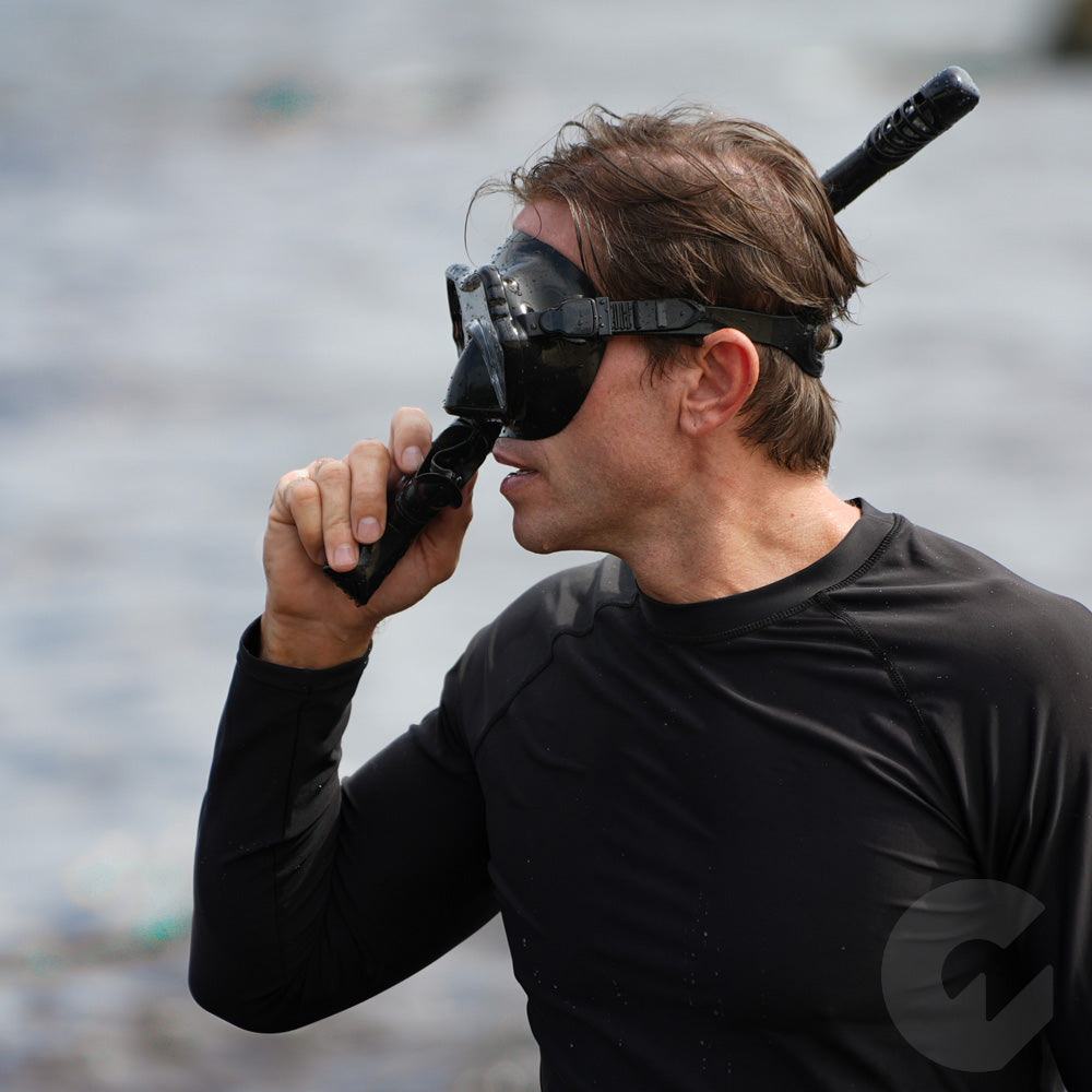 Adult model wearing G2rise snorkeling mask, designed for underwater breathing and exploration